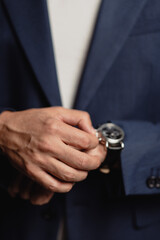 businessman holding a watch