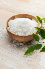 Magnesium flakes in wooden bowl for wellness and relaxation