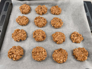 Freshly baked oatmeal cookies cooling on baking tray