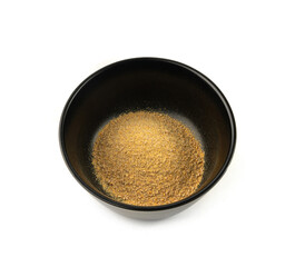 Ground fenugreek seeds in black bowl, milled dry trigonella powder, spicy methi dana pounded