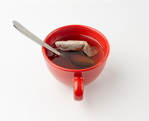 Herbal tea sachet in cup, hot water with chamomile and Hypericum or St. John's wort teabag