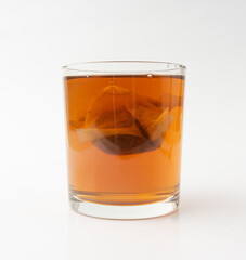 Herbal tea sachet in glass, hot water with chamomile and Hypericum or St. John's wort teabag