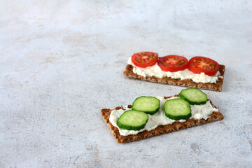 Cracker snacks with fresh vegetables and cream cheese