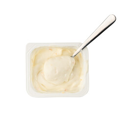 Yogurt cup isolated, yoghurt with orange fruits pieces in plastic pot, spoon in milk pudding