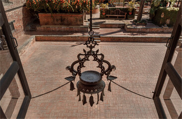 -Looking out of a window  at a court yard with a large traditional candle holder