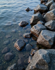 Fototapeta premium dark rocks partially submerged in clear water creating a tranquil scene
