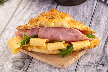 Fresh croissant with ham and cheese