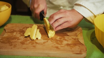 Chefs Hands Cut Long Italian Potatoes into Sticks to Fry Them