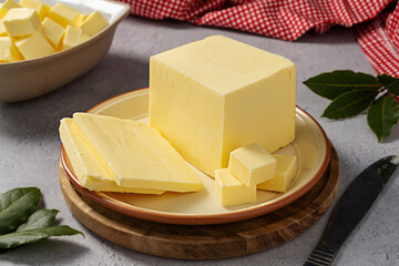 Butter block, grass-feed butter slices over wood cutting board. Vitamin D and source of fat 