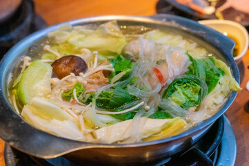A steaming hot pot feast brings together fresh ingredients and rich flavors in a warm, communal dining experience. The bubbling broth, infused with aromatic spices, serves as the perfect base for cook