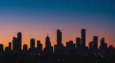 Fototapeta premium Urban Twilight Skyline: Geometric Silhouettes and Twinkling Lights
