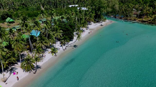 Experience the tranquility of Koh Kood Thailands coastal paradise, featuring soft white sands, lush palm trees, and crystal-clear turquoise waters.