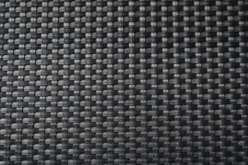 black background with rattan weave texture