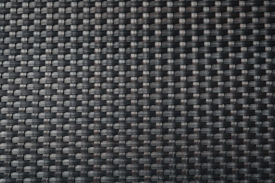 black background with rattan weave texture