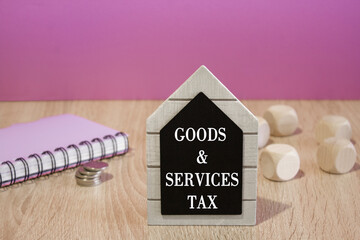 Goods and Services Tax symbol. Concept words Goods and Services Tax on black board. Beautiful...