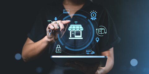 Woman using tablet with holographic e-commerce icons for online shopping.