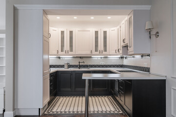 design of modern built-in kitchen in minimalist style. kitchen set with white and dark wooden cabinets. built-in kitchen appliances. white countertop, white walls. countertops in kitchen corner