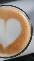 Cup of coffee with heart, a morning beverage with caffeine. Homemade drink