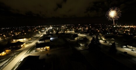 A brilliant firework display illuminates a residential suburban neighborhood at night