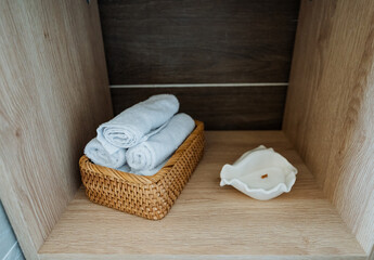 On a wooden shelf that blends perfectly with the decor, you can find a cozy basket filled with soft...