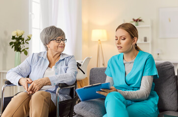 Obraz premium Kind woman nurse, doctor gives help, support to handicapped old lady patient sitting in wheelchair, female caregiver happy to assist, take care of smiling senior disabled grandma, elderly healthcare