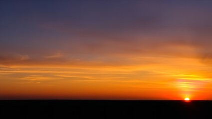 Obraz premium A Sweeping Sunset Panorama with Warm Vibrant Hues