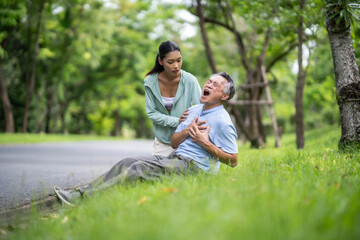 A daughter helping her father, old elderly sick senior Asian man got heart attack  at park. Health problem. Retired old man chest pain outdoor. Life and insurance concept.