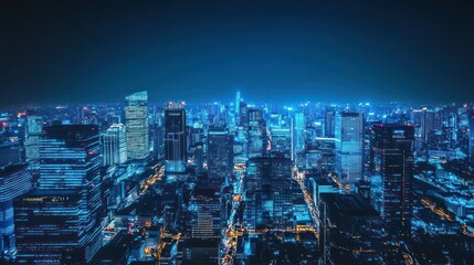 Fototapeta premium Cityscape aerial view at night, illuminated buildings, urban lights. Possible use Stock photo for city planning, urban development, architecture, night photography
