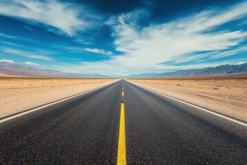 Naklejka premium Empty Road stretches to horizon under sunny sky in desert, travel destination