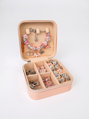 Beige open box with finished bracelet and beads, children's handicrafts
