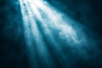 Blue spotlight beams cutting through smoky darkness.