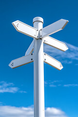 Directional signpost with multiple arrows under a clear blue sky in a sunny location