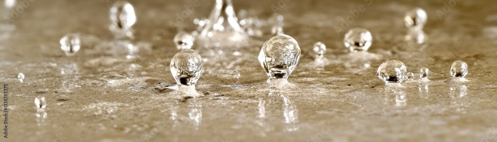 Poster Water droplets impacting on a surface with reflections creating a unique effect