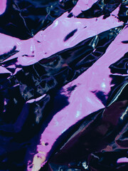 Crushed metal sheet with neon pink reflections