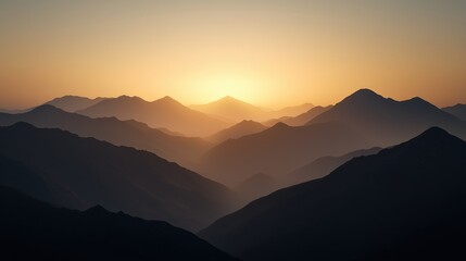 Obraz premium Golden Sunset Washes Over Rugged Peaks of Majestic Mountains in Serene Landscape