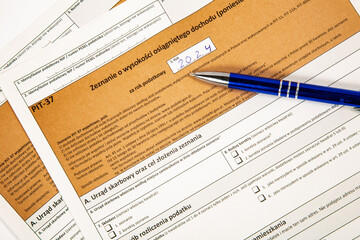 Close-up. Background. PIT-37. Polish tax return form for 2024 (called PIT) with pen.