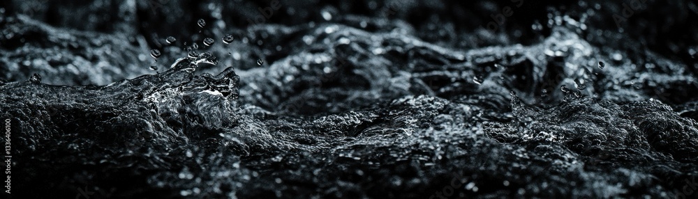 Poster Water surface breaking with droplets in a dark environment setting