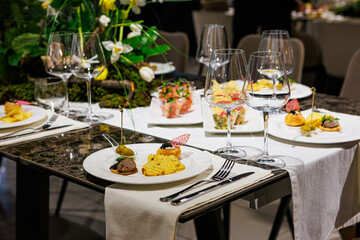 Elegant gourmet appetizers served on white porcelain.