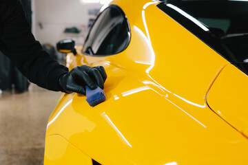 Detailing ceramic polishing at the car service. Process of applying a ceramic coating to the sports...