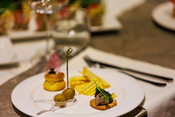 Elegant gourmet appetizers served on white porcelain.