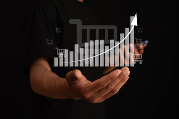 Sales growth concept. Businessman using laptop with graph showing sales volume growth and icons on virtual screen.