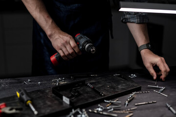 Master Changes Drill Bit On Drill With Hands In Close-Up View