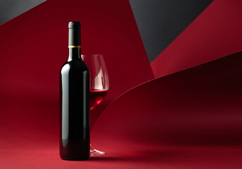 Bottle and glass of red wine.