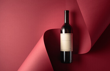 Bottle of red wine and blue grapes.