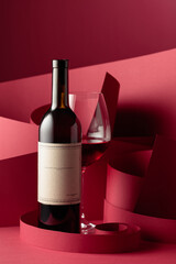 Bottle and glass of red wine.