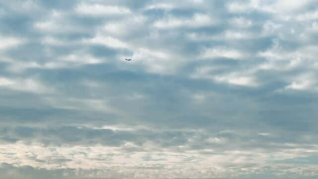 Airplane fly up over the cloudy sky, Passenger flight plane silhouette, dramatic sky. Aircraft departure. International transport flying