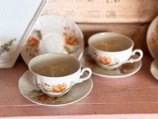 vintage floral teacup set on rustic wooden shelf