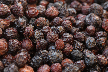 Rich hues of dried berries scattered across a rustic wooden surface in vibrant market display
