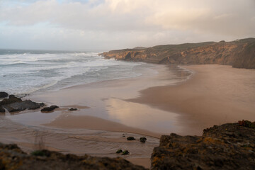 Wild Coastal Beach with Dramatic Cliffs and Waves