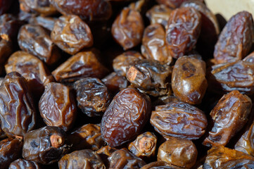 Richly textured dates displayed in a traditional market setting at midday